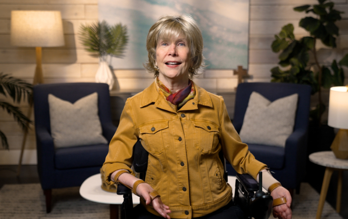 Joni Eareckson Tada smiling for the camera in a cozy living room setup.