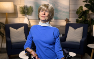 Joni Eareckson Tada smiling for the camera in a cozy living room setup.