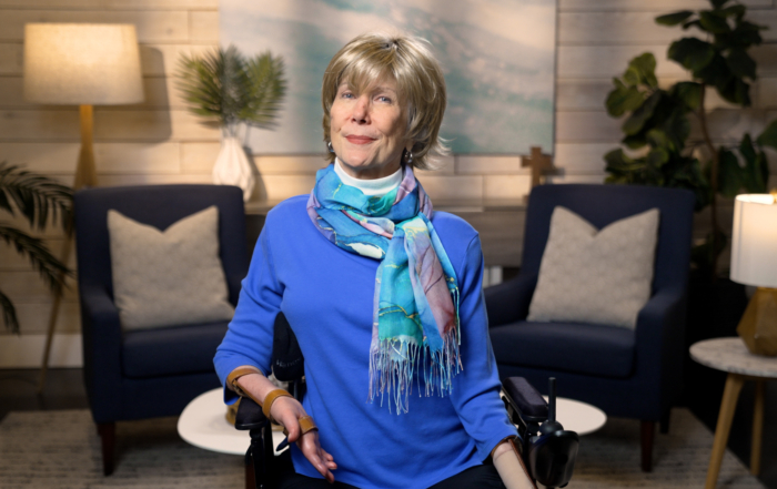 Joni Eareckson Tada smiling for the camera in a cozy living room setup.