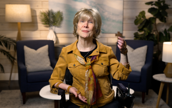 Joni Eareckson Tada smiling for the camera in a cozy living room setup.