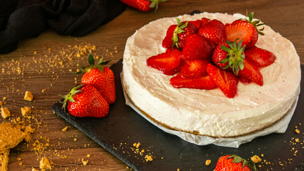 A cheesecake topped with fresh strawberries