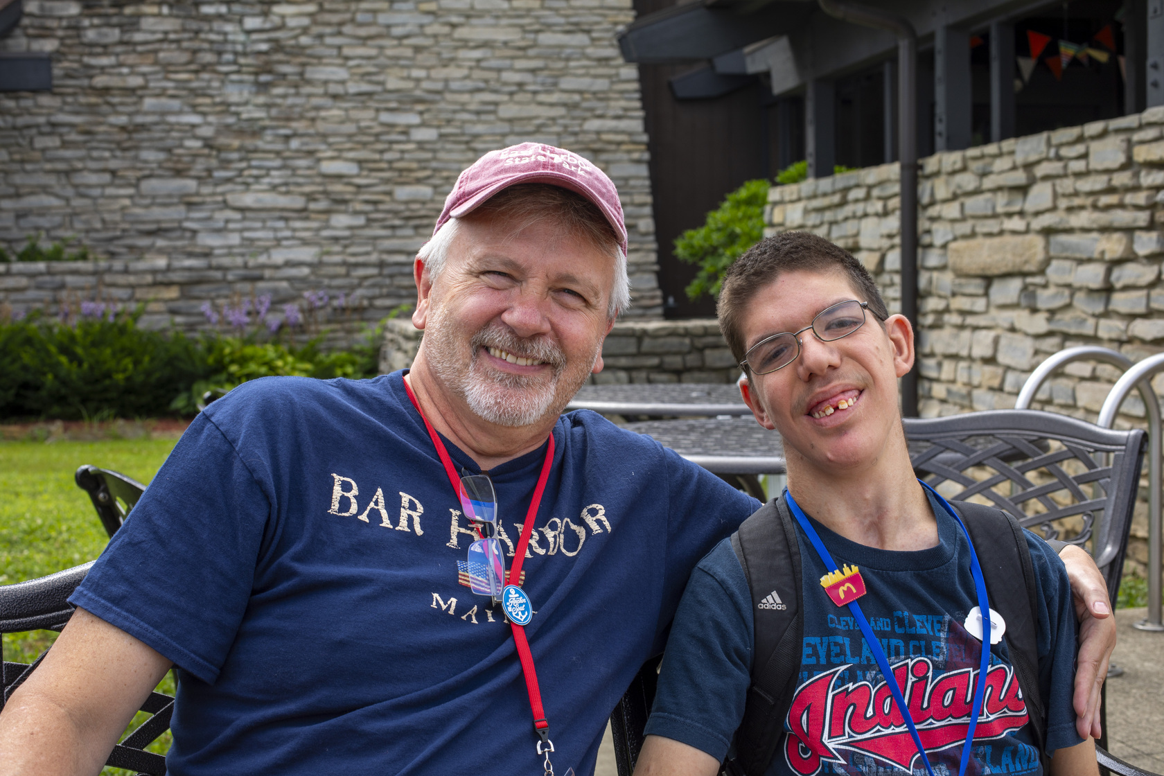 Rick smiling with one of his children while sitting together, sharing a joyful moment at Joni and Friends Family Retreat.