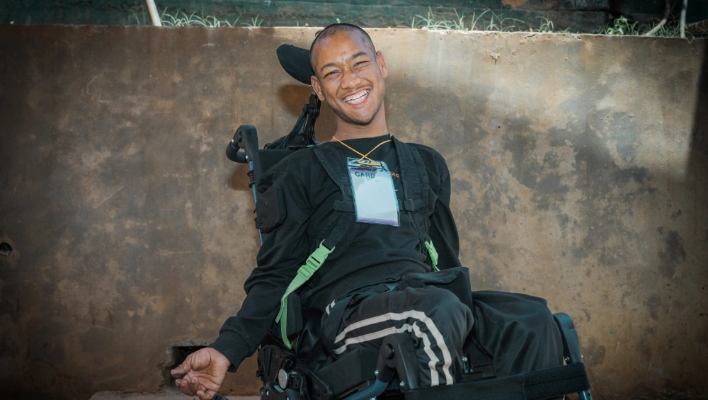 A man smiles in his new wheelchair