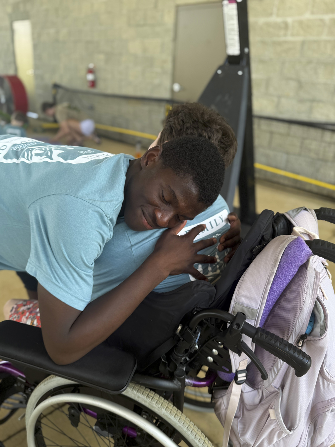 After a fun round of games at rec, Asher pulls his sister in for a big hug.