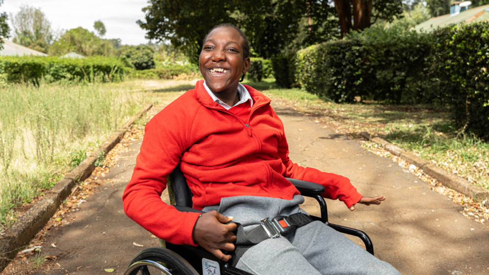 A boy smiles in his new wheelchair