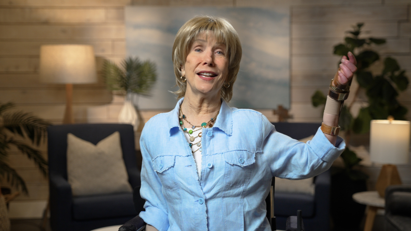 Joni Eareckson Tada smiling for the camera in a cozy living room setup.