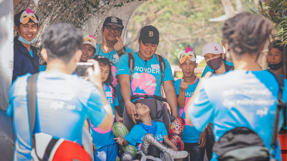 Joni and Friends events A group of people in blue shirts pose for a photo and make a heart gesture