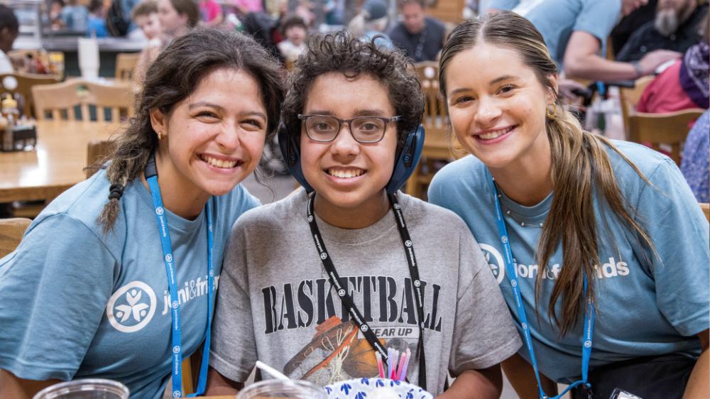 Campers and volunteers pose for a photo at Family Retreat