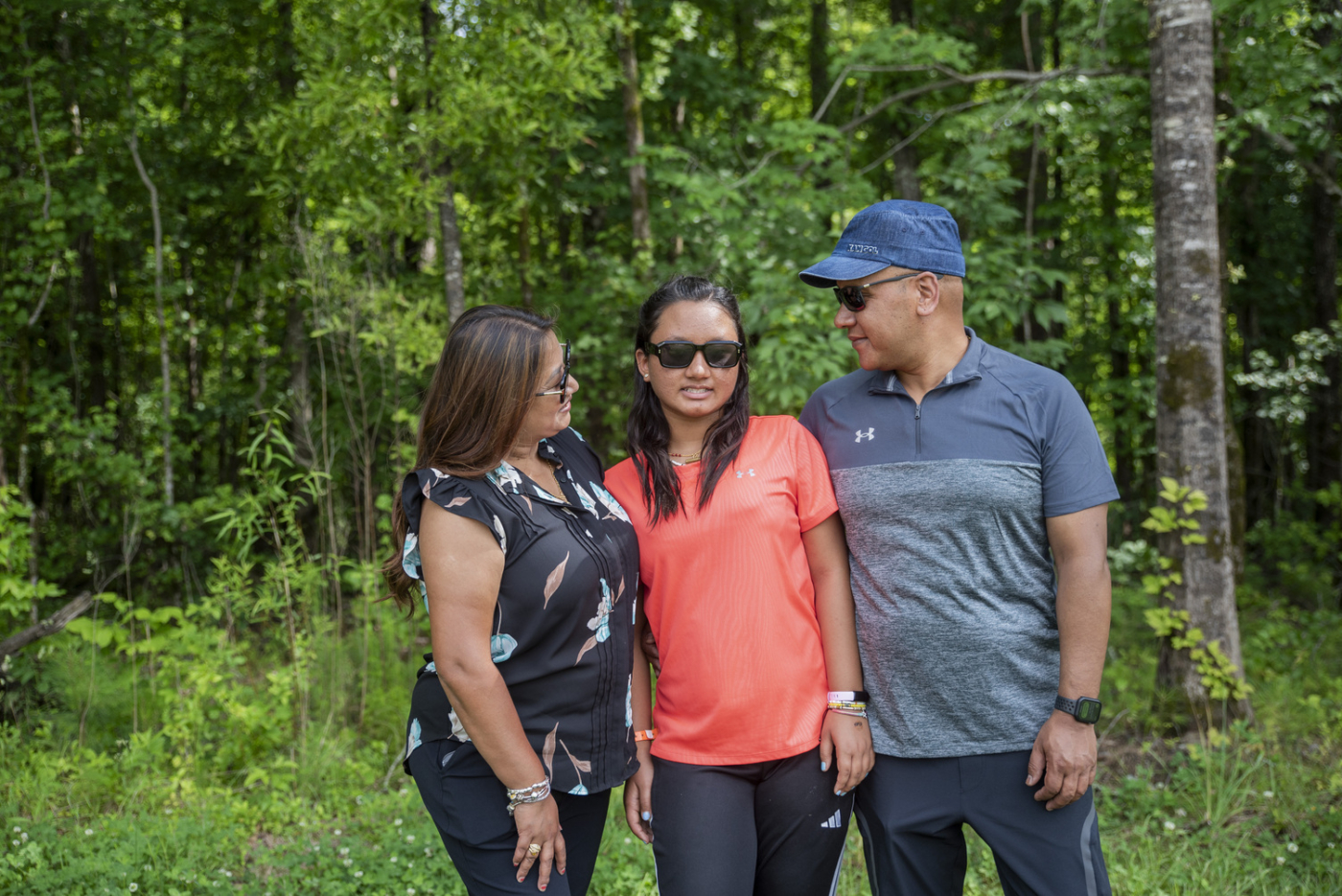 Aruna and her husband look at their daughter Sana.