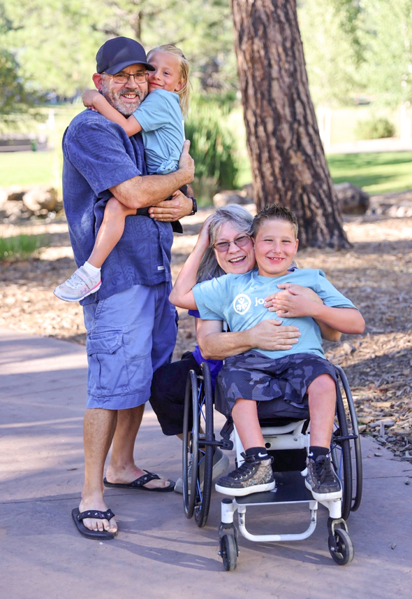 Callie and Conrad pose happily with Todd and Nanette, their first Joni and Friends buddies, who have since become honorary grandparents to their family.