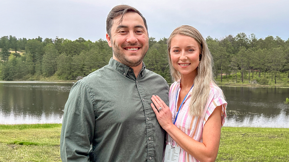 A couple pose for a photo at Marriage Getaway