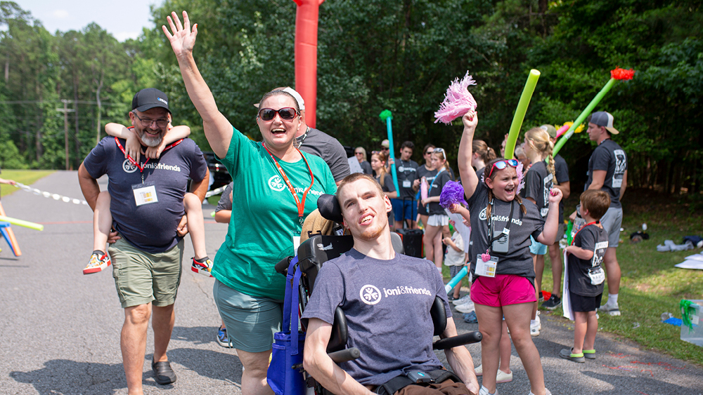 A group of campers and volunteers pose for a photo