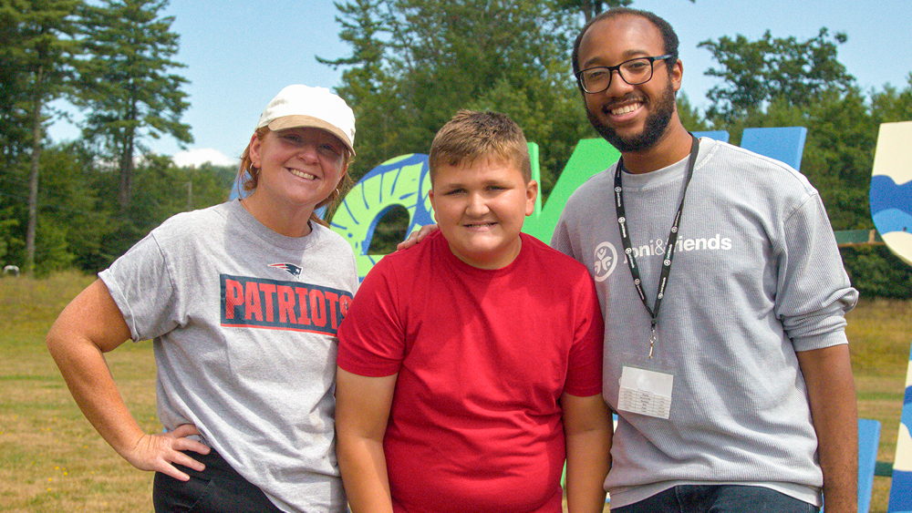 Campers and volunteers pose for a photo at Family Retreat