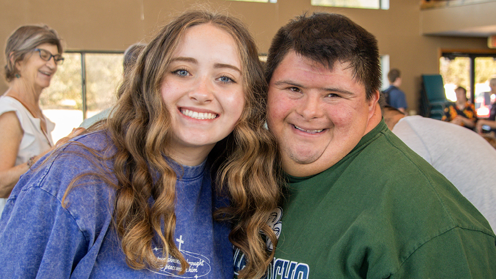 Joni and Friends Family Retreat A volunteer and camper pose for a photo at Family Retreat