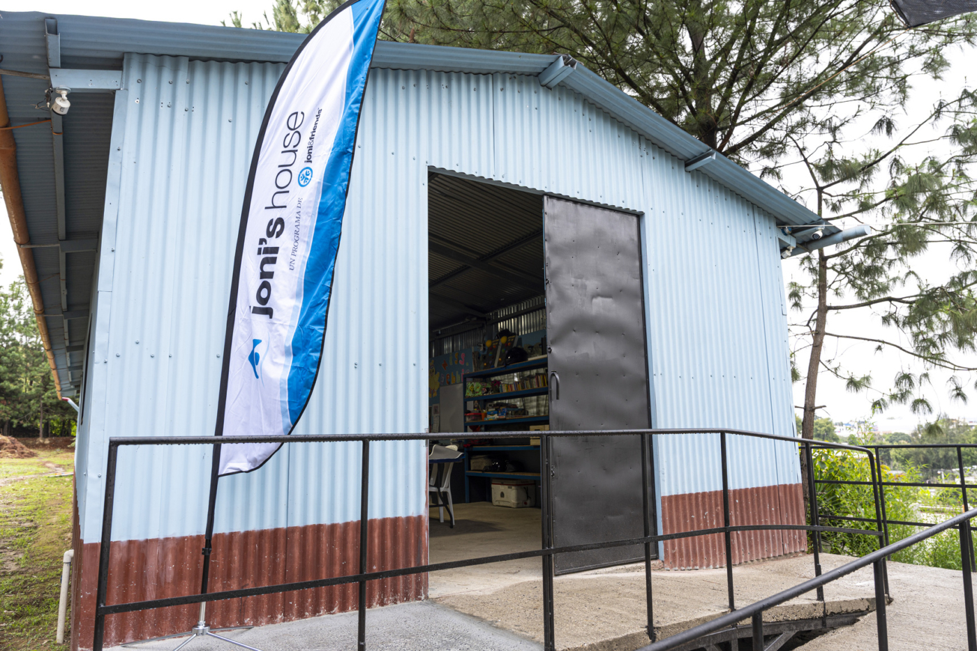 A small house with a Joni and Friends flag hanging outside.