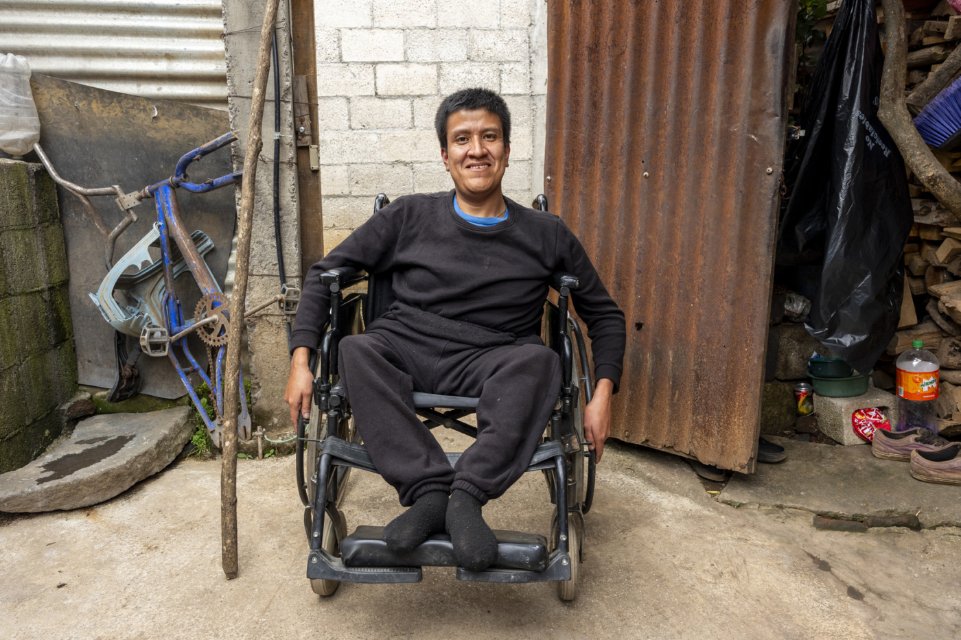 Javier smiling for the camera while in his new wheelchair.