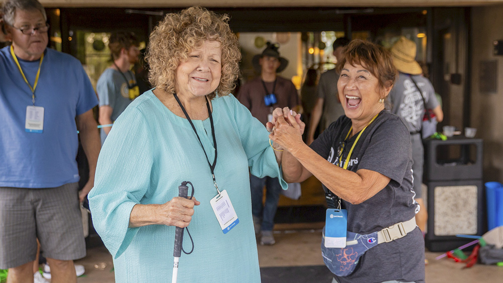 People joyfully pose for a photo at a Joni and Friends event