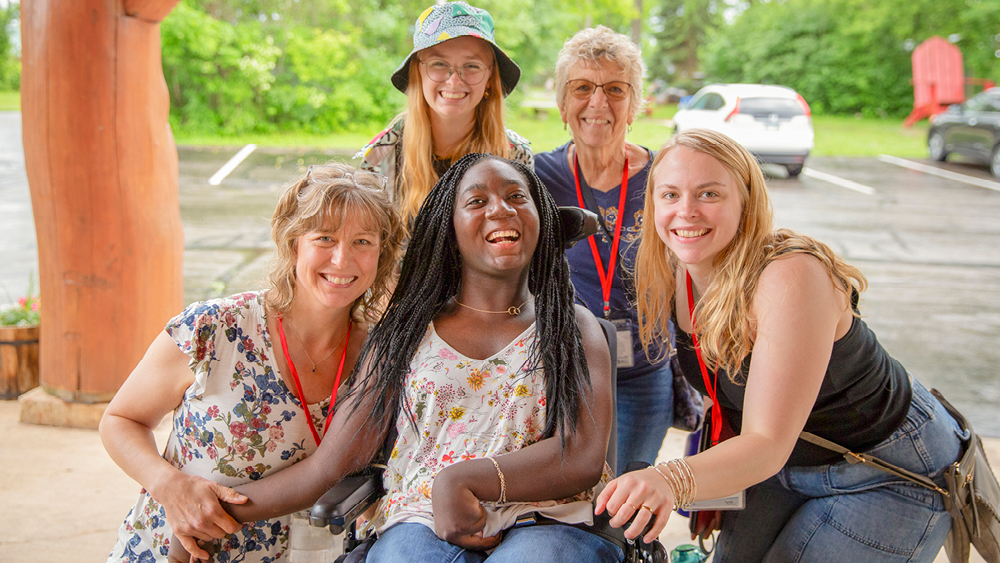Campers and volunteers pose for a photo at Family Retreat