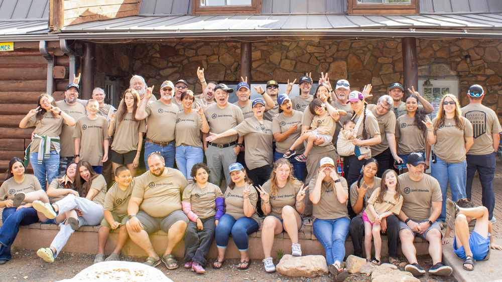 A group of veterans and their families pose for a photo