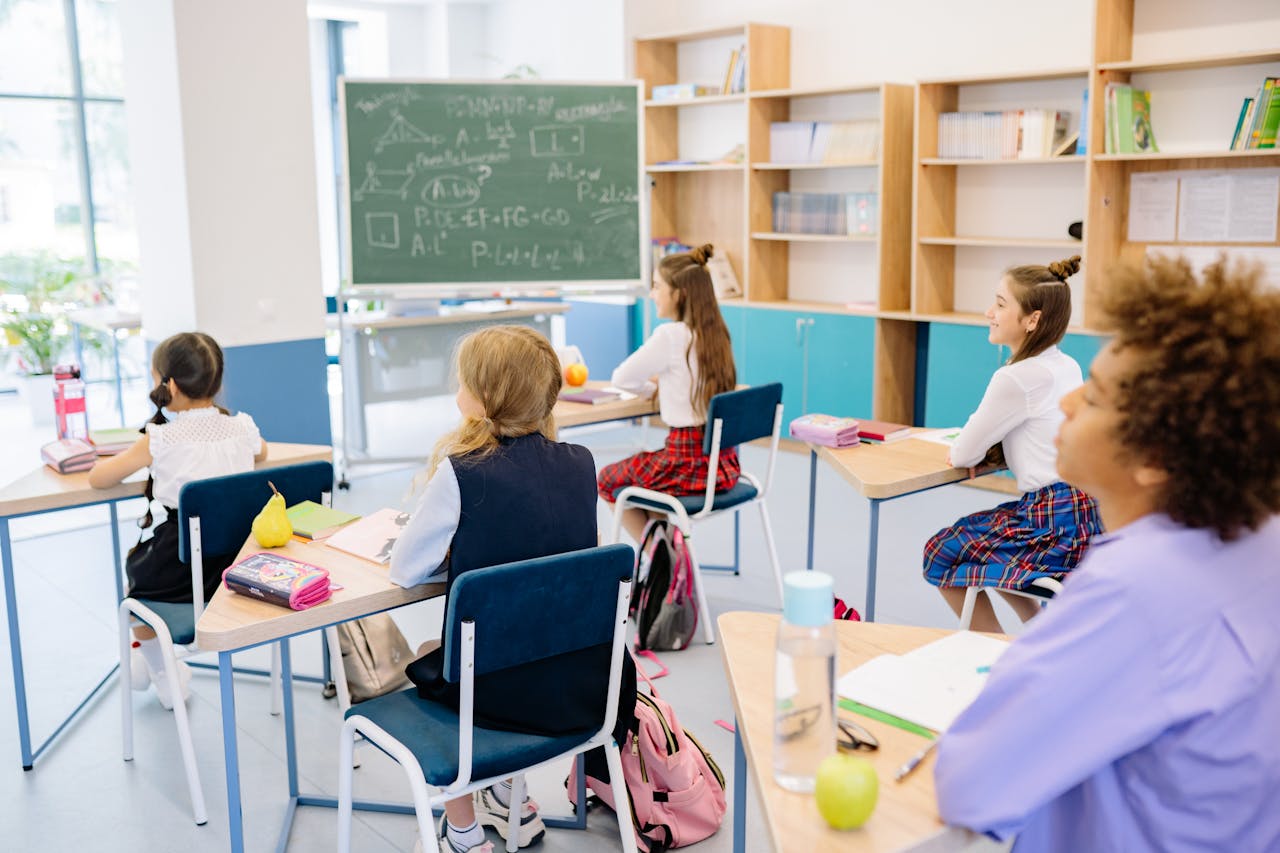 Students sitting in a classroom listening attentively.