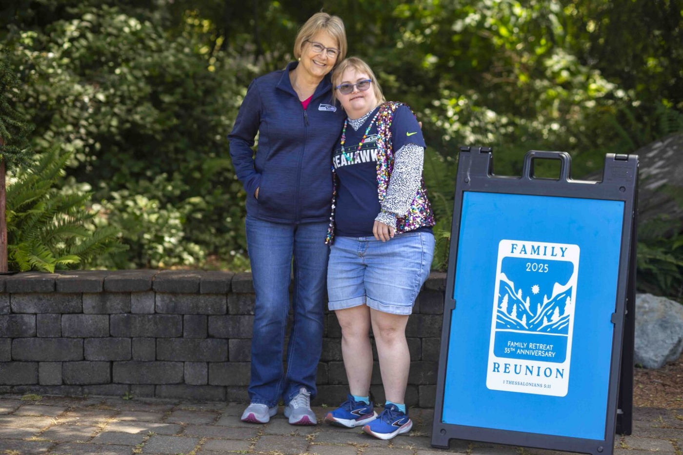 Emily stands beside her mom as they smile and pose for the camera.