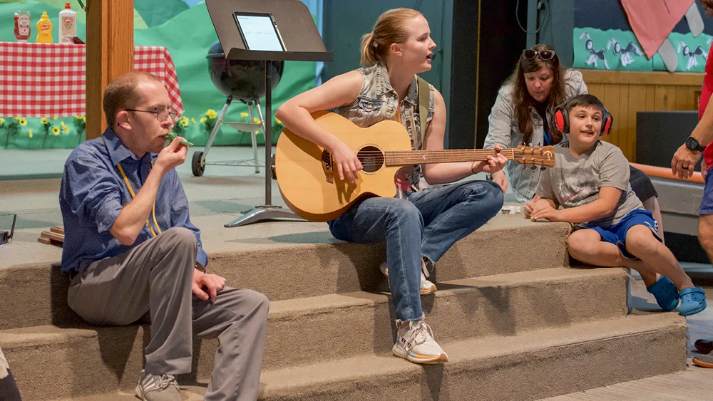 A group of people leads worship on stage