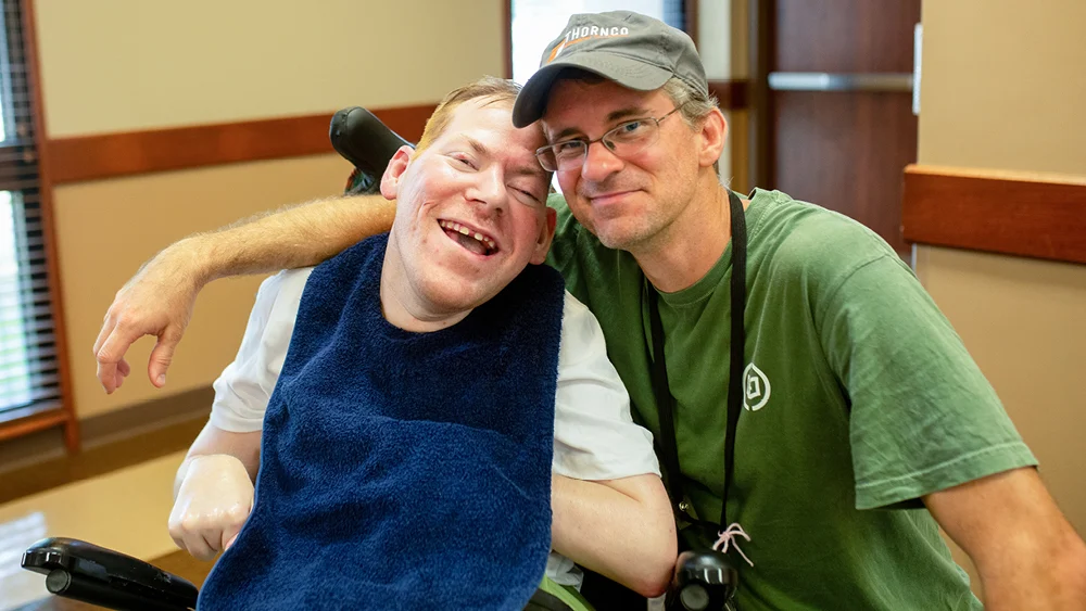 Two men pose for a photo at a Joni and Friends event