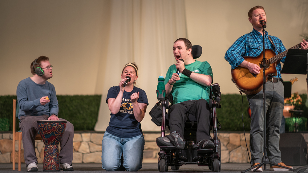 A group of people lead worship at a Joni and Friends event