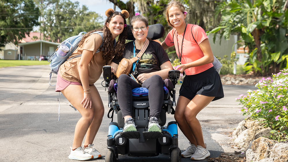 Campers and volunteers pose for a photo at a Family Retreat