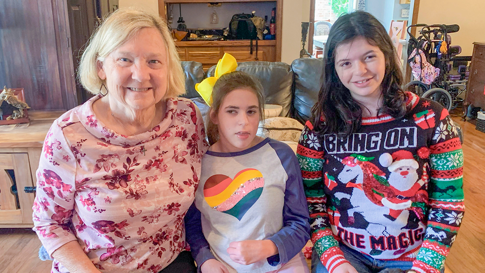 People pose for a photo with Christmas sweaters