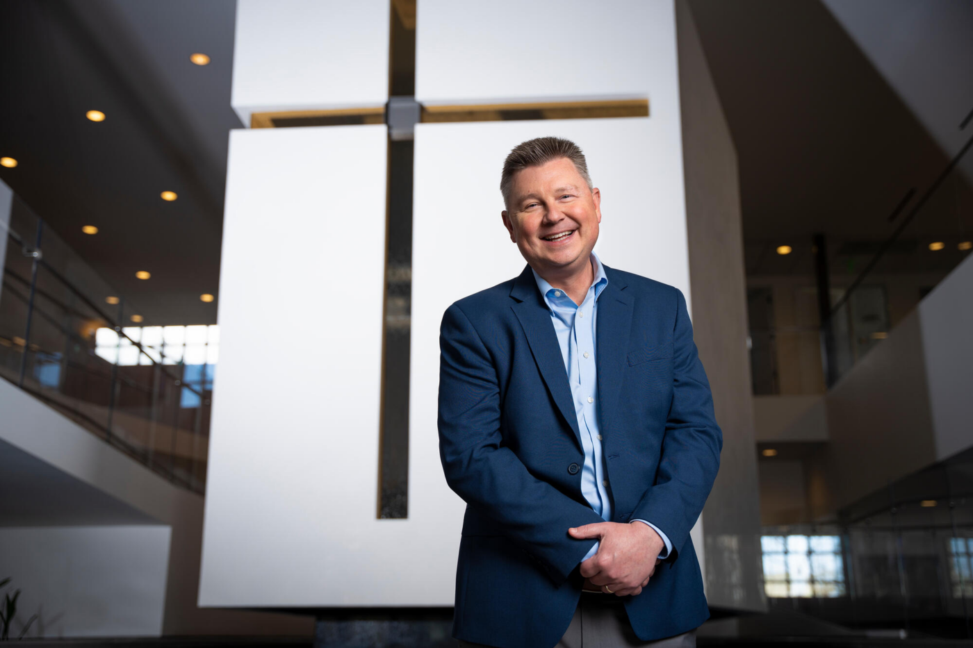 Steve Bundy smiling and posing in front of a chapel.