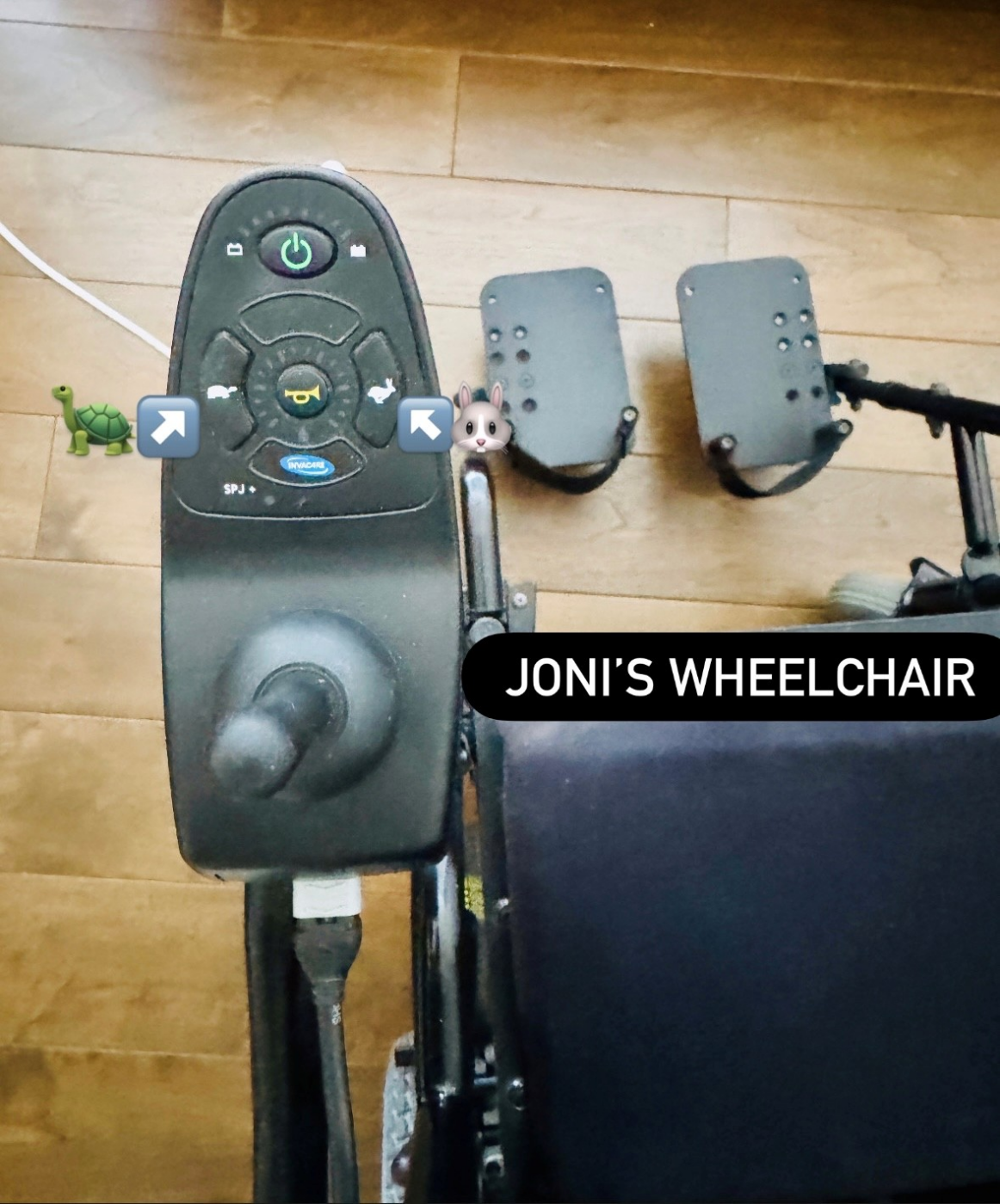 A photo of the buttons on Joni's wheelchair. There is a power button, a turtle button, and rabbit button
