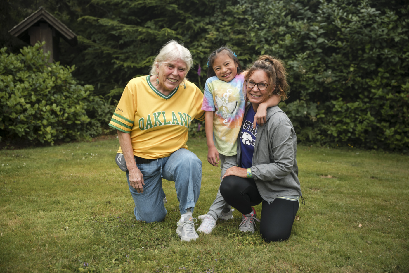 Isla smiling and posing for the camera with two women standing next to her.