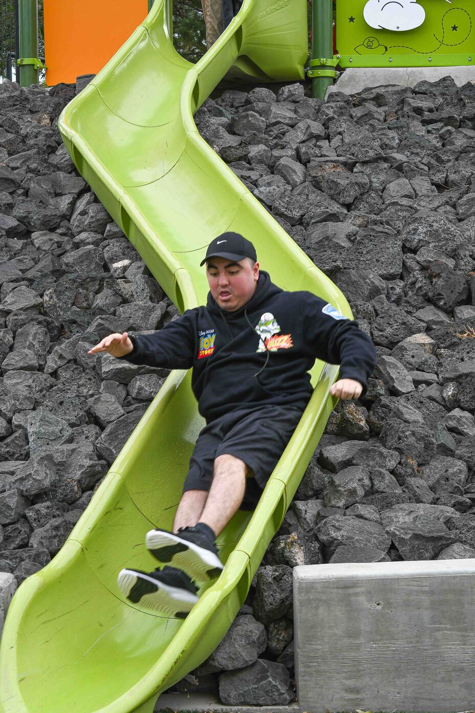 Ricky slides down a playground slide.