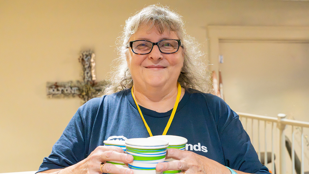 A person holding coffee cups