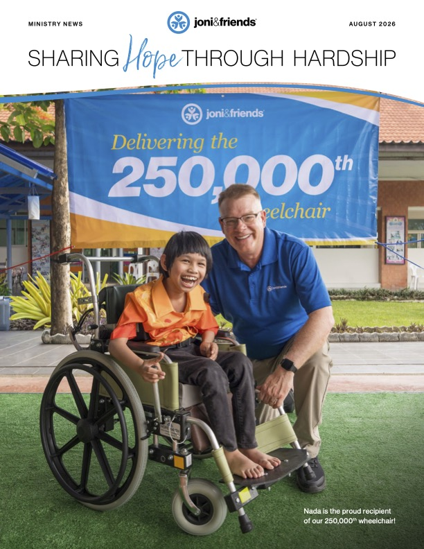 Newsletter cover for August 2026 featuring Nada, a girl from Thailand, in her new wheelchair beside Joni and Friends President Shawn Thornton. They are in front of a banner reading, "Joni and Friends Delivering the 250,000th Wheelchair." The cover title reads, "Sharing Hope Through Hardship," and the text at the bottom says, "Nada is the proud recipient of our 250,000th wheelchair!"