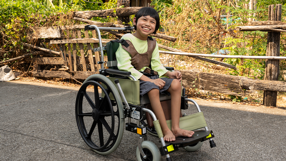 Nada smiling in her new wheelchair