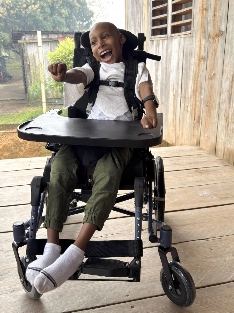 Jareth smiling in his new wheelchair