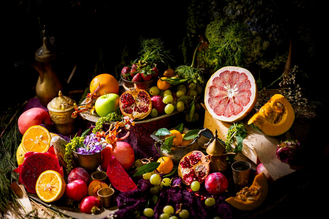 A colorful and artistic still life of assorted exotic fruits and vegetables, showcasing a vibrant and lush composition.